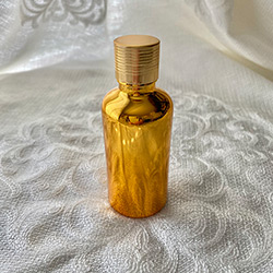 Buy a Little Glass Bottle, in Gold Glass, with a Gold Screw Lid, 50ml at The Surf Haberdashery